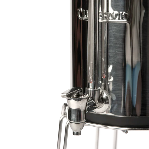 Close-up of Woder Clearbrook 2.25 Gallon gravity water filter stainless steel spigot and sight glass on lower vessel with metal stand