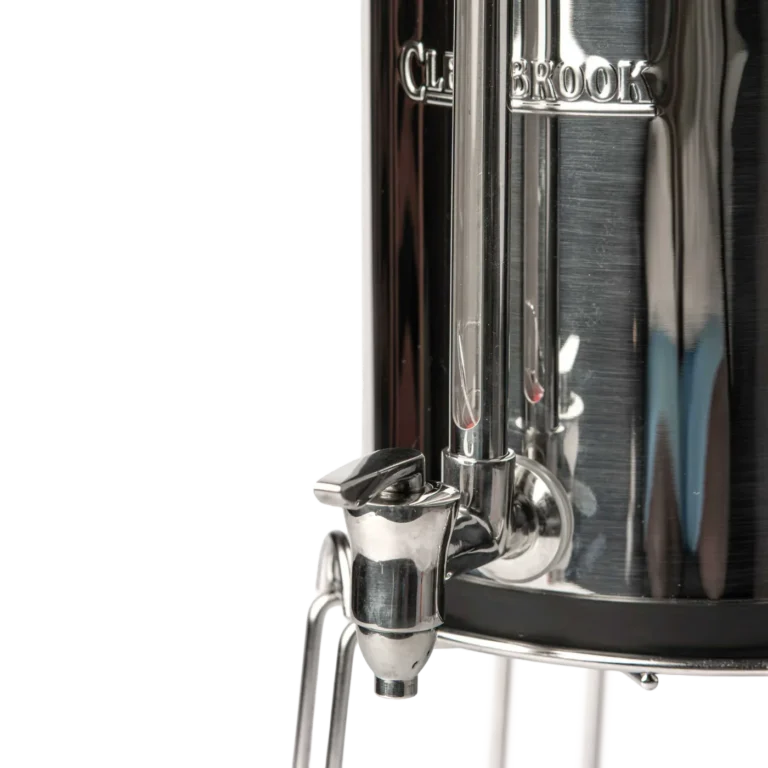 Close-up of Woder Clearbrook gravity water filter stainless steel spigot and sight glass on lower vessel with metal stand